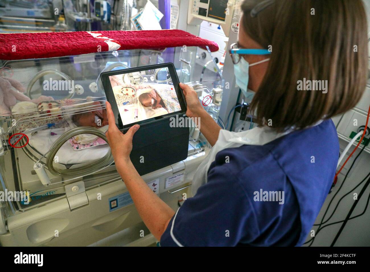 File photo dated 27/5/20 of a nurse making a video of a newborn baby in