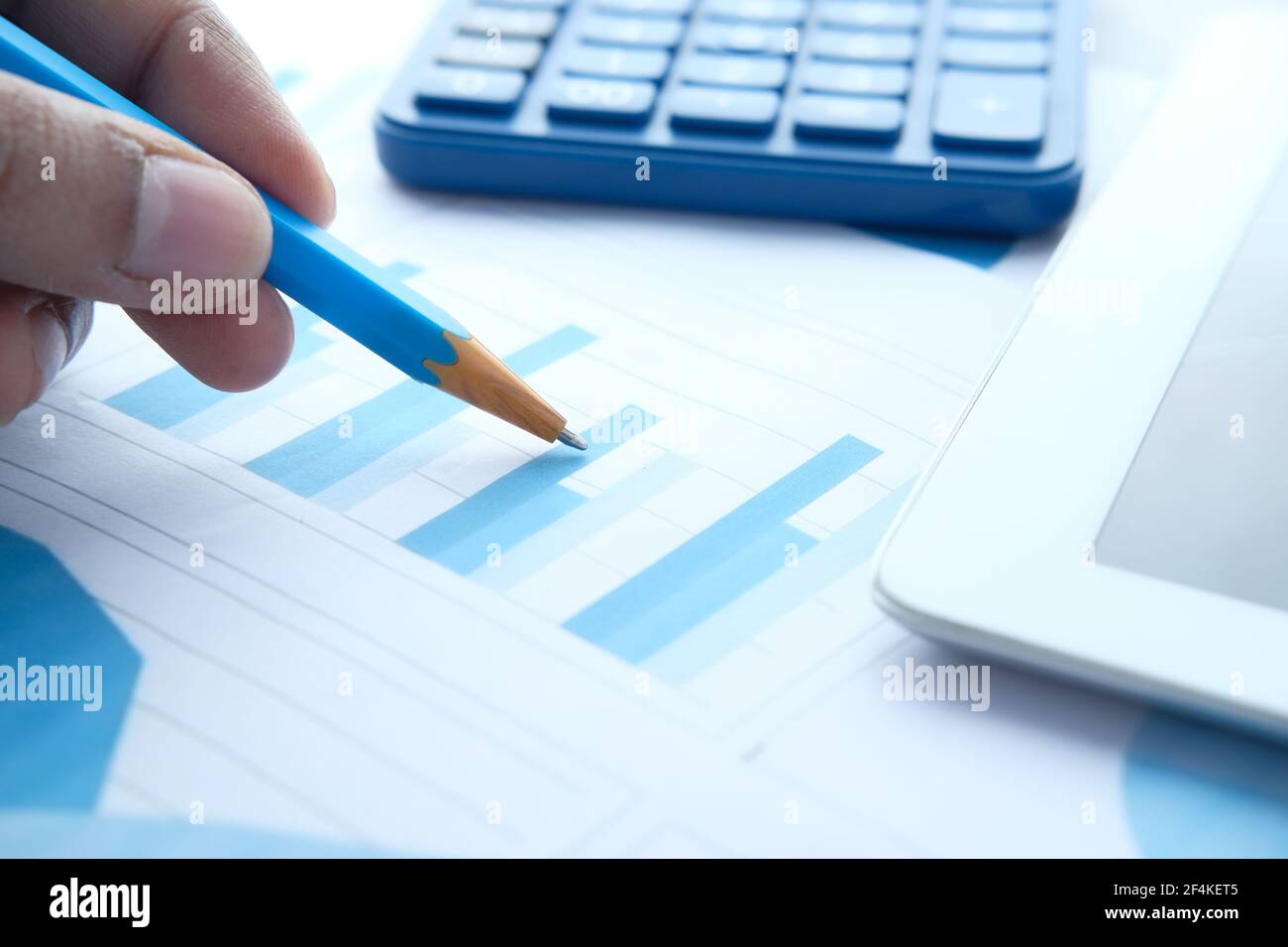 hand with pencil analyzing bar chart on paper Stock Photo - Alamy