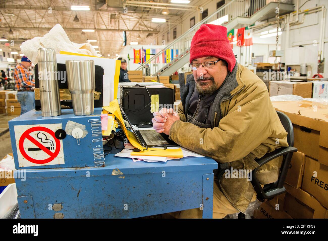 New York City, USA. Wholesale market stall employee waiting to crunch