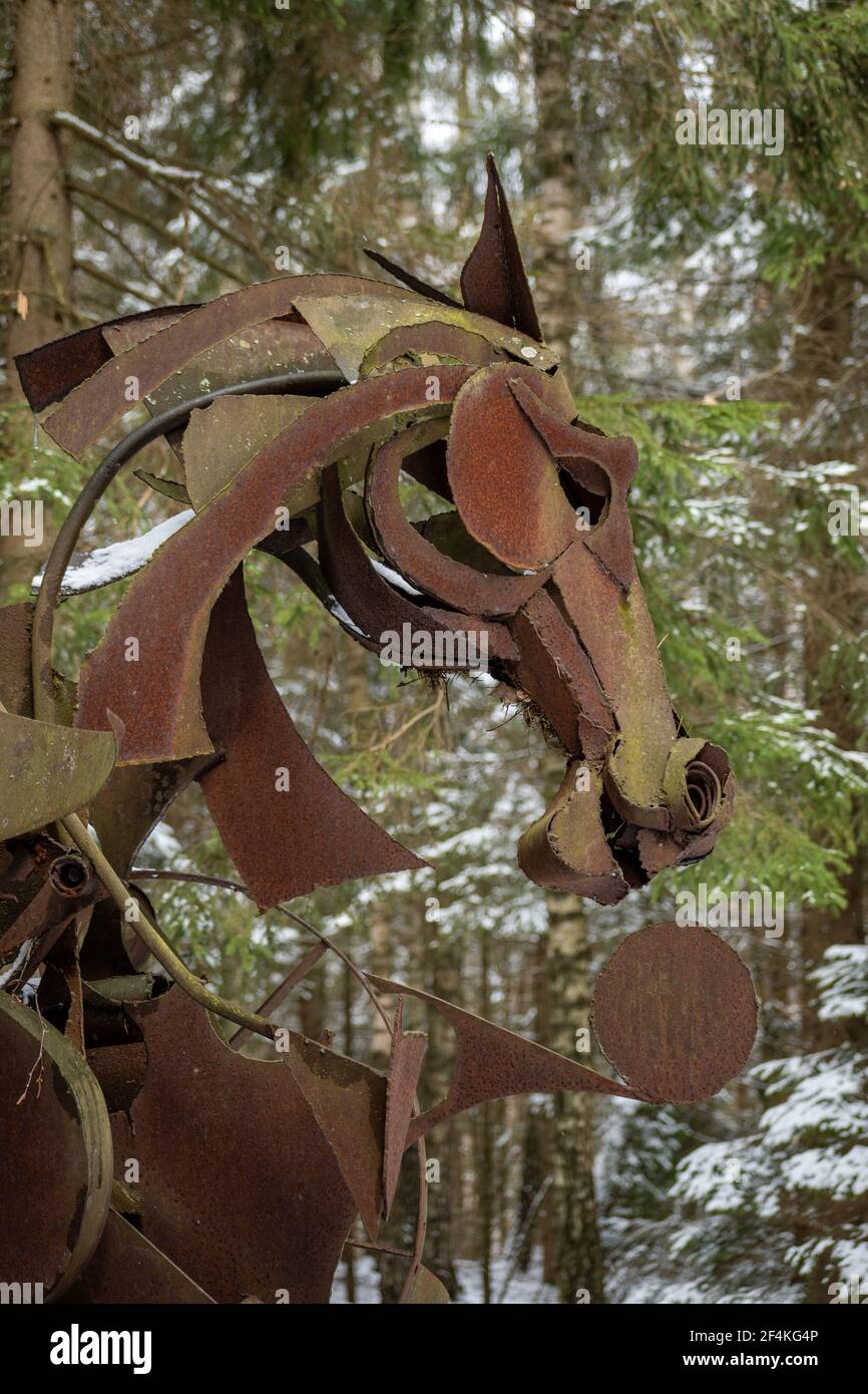 Creepy horse face in a wood, rusted iron sculpture, vertical Stock