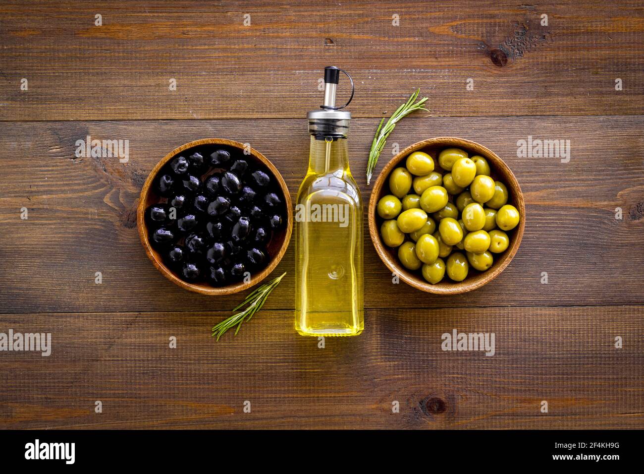 Olive oil in bottle with green and black olives, top view Stock Photo