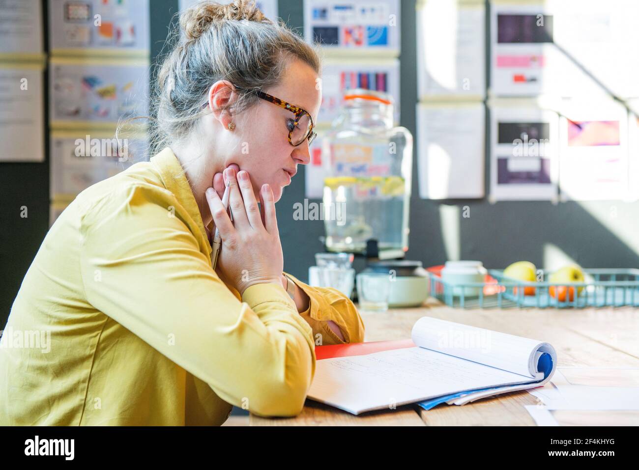 Utrecht, Netherlands. Young, brunette female making notes during an interview on the Hart Island Project. Stock Photo