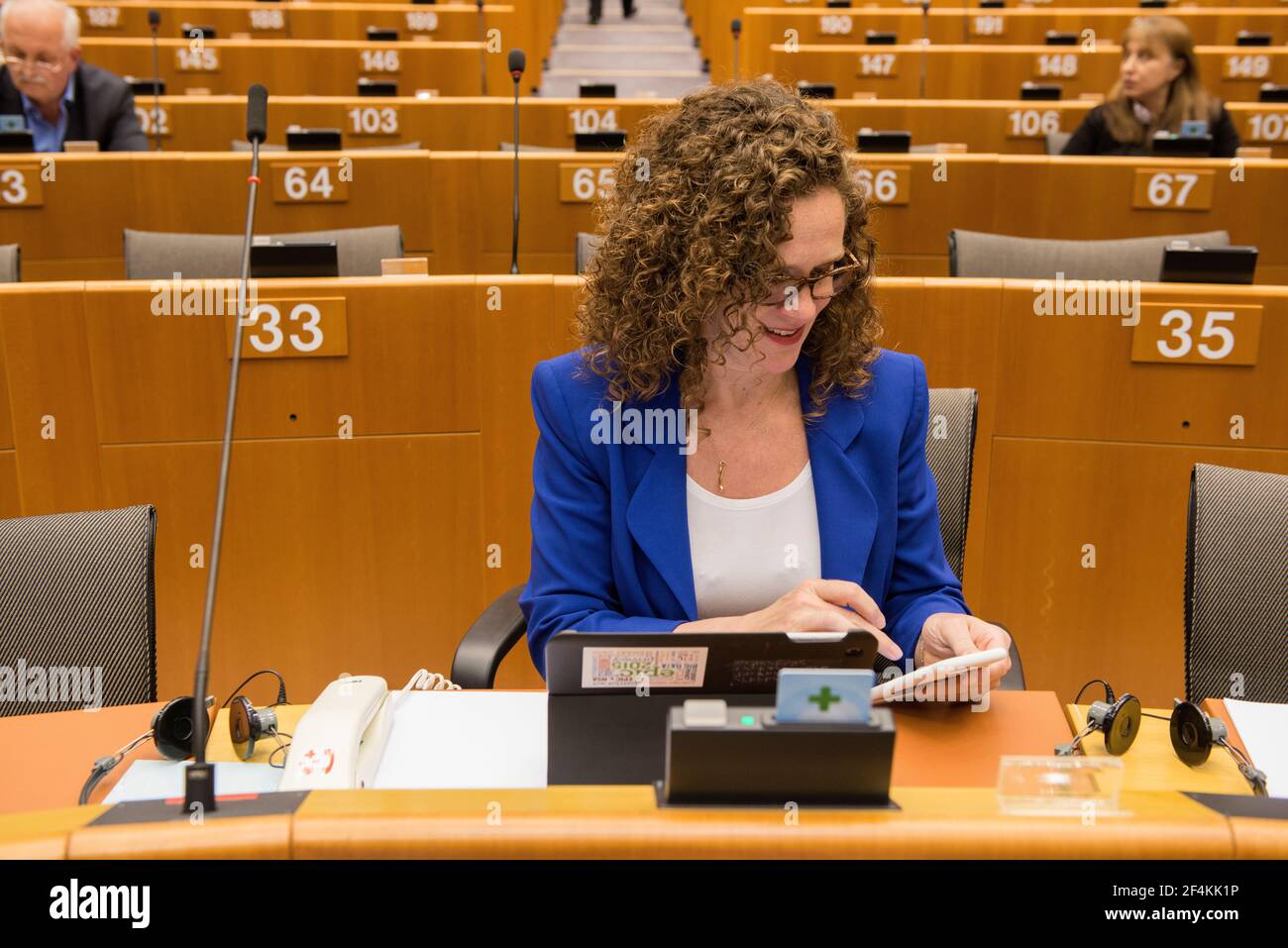 Brussels, Belgium. Member of European Parliament, Mrs. Sofia in 't Veld in her seat, checking the messages on her smartphone. Stock Photo