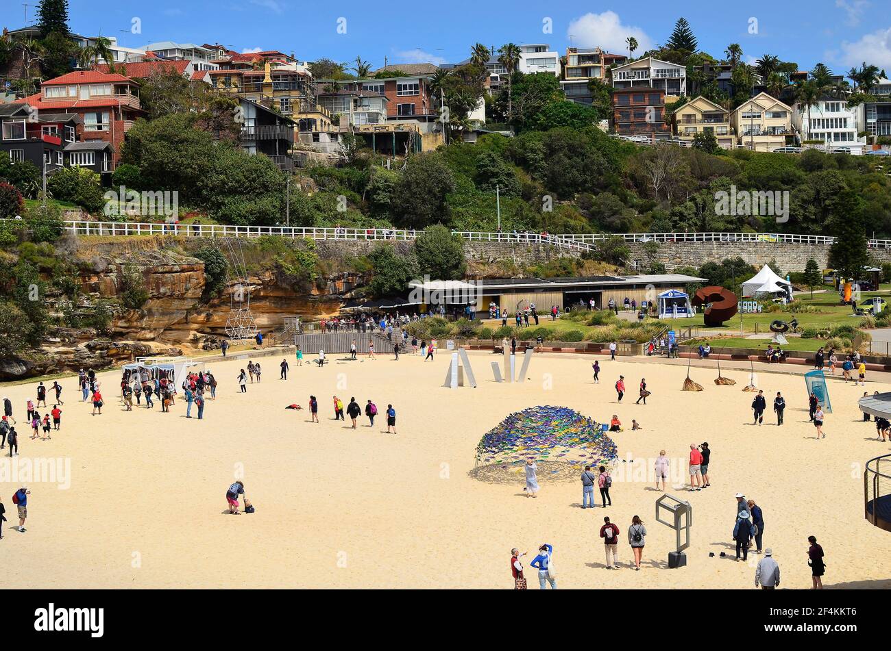 Sydney, NSW, Australia - October 31,2017: Unidentified people on Tamarama beach, homes and different artworks from outdoor exhibition Sculpture-by-the Stock Photo