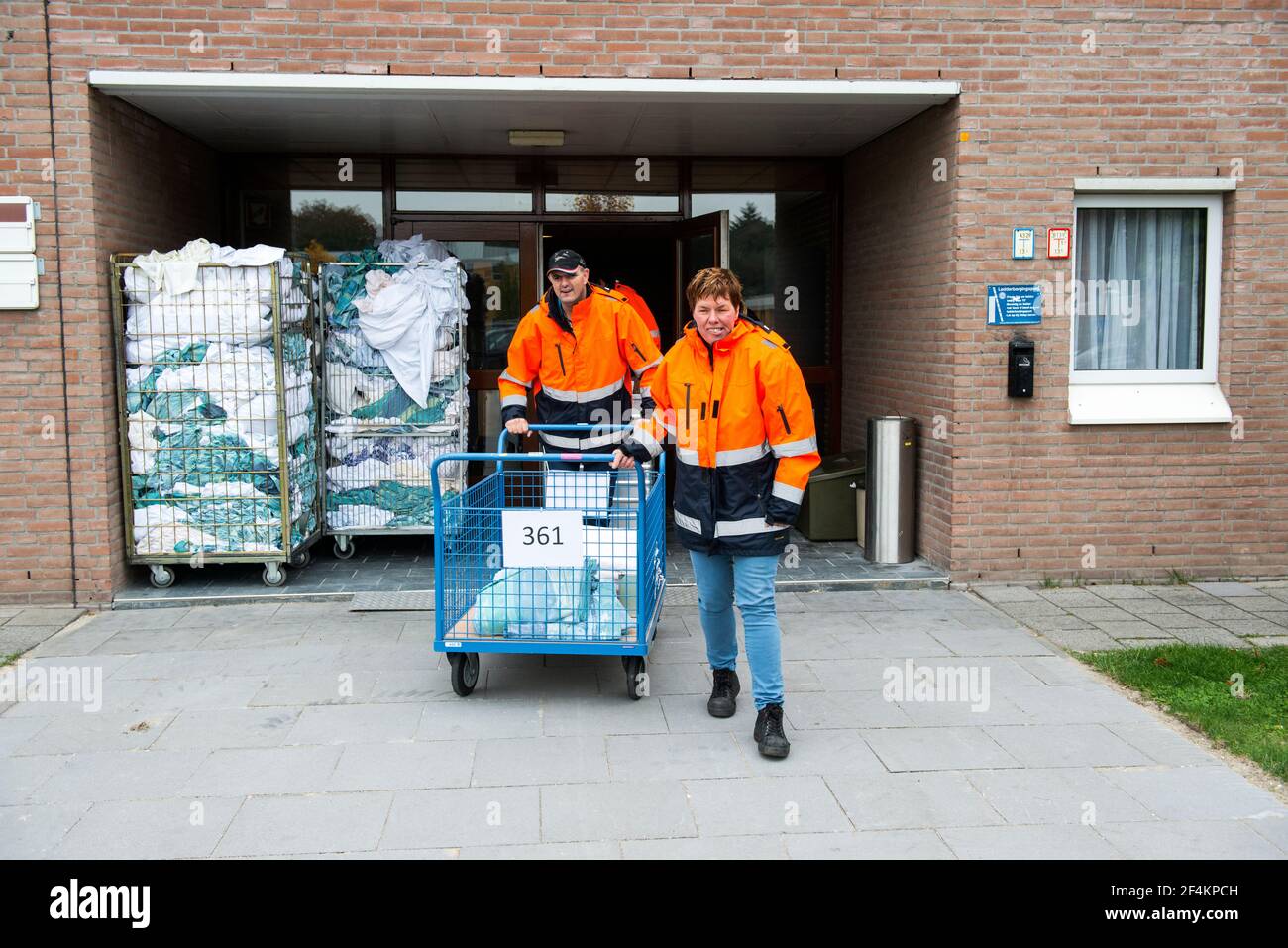 Airbase, Gilze-Rijen, Netherlands. Multiple mentally challenged civilian employees of a Dutch Airbase taking care of laundry at the Dutch airforce base. Stock Photo