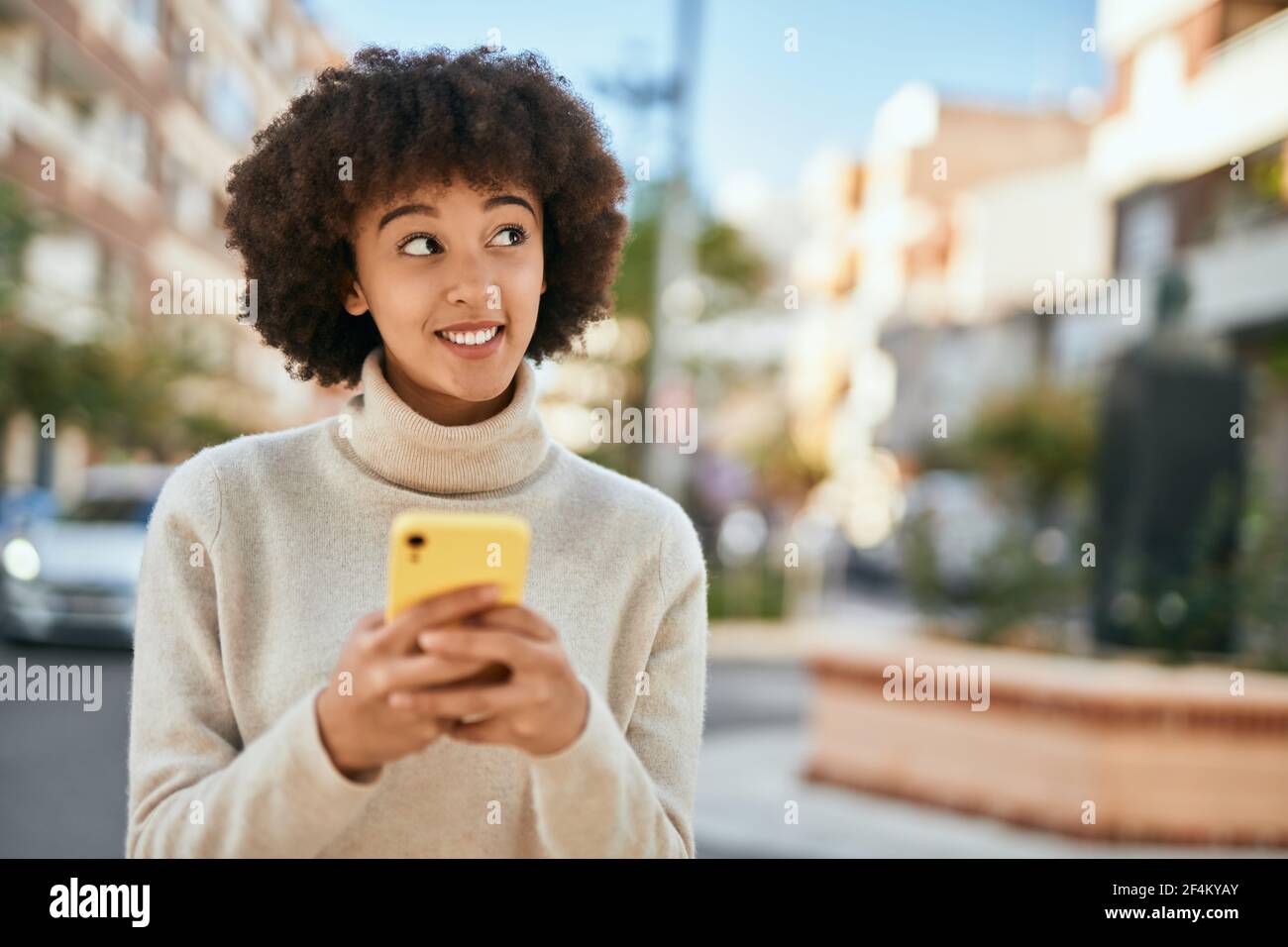 Young hispanic girl smiling happy using smartphone at the city Stock ...