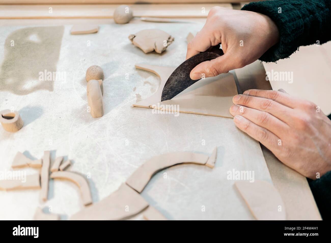 Stock photo of unrecognized person shaping clay in pottery class. Stock Photo