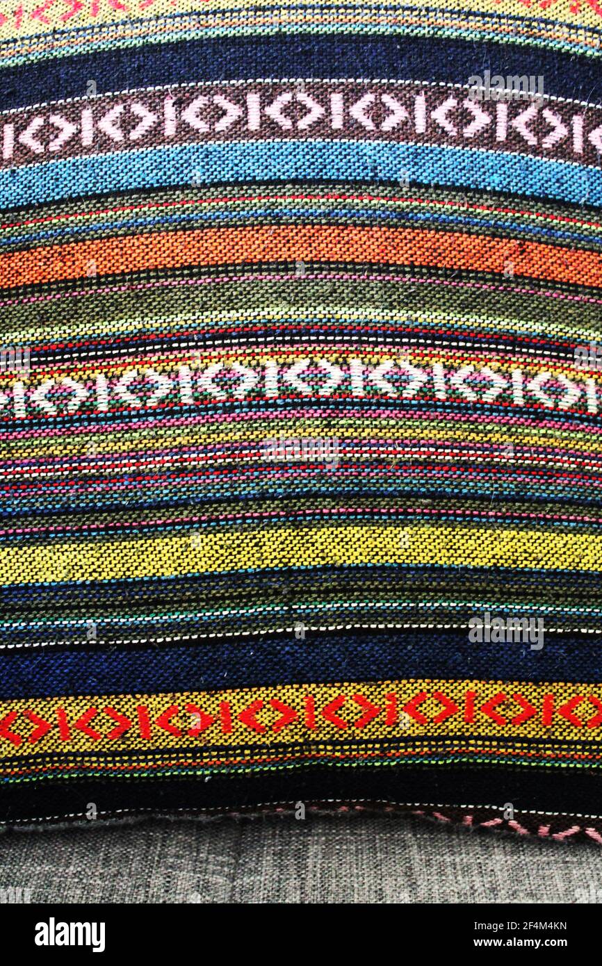 detail of colorful woven bands on a throw pillow Stock Photo