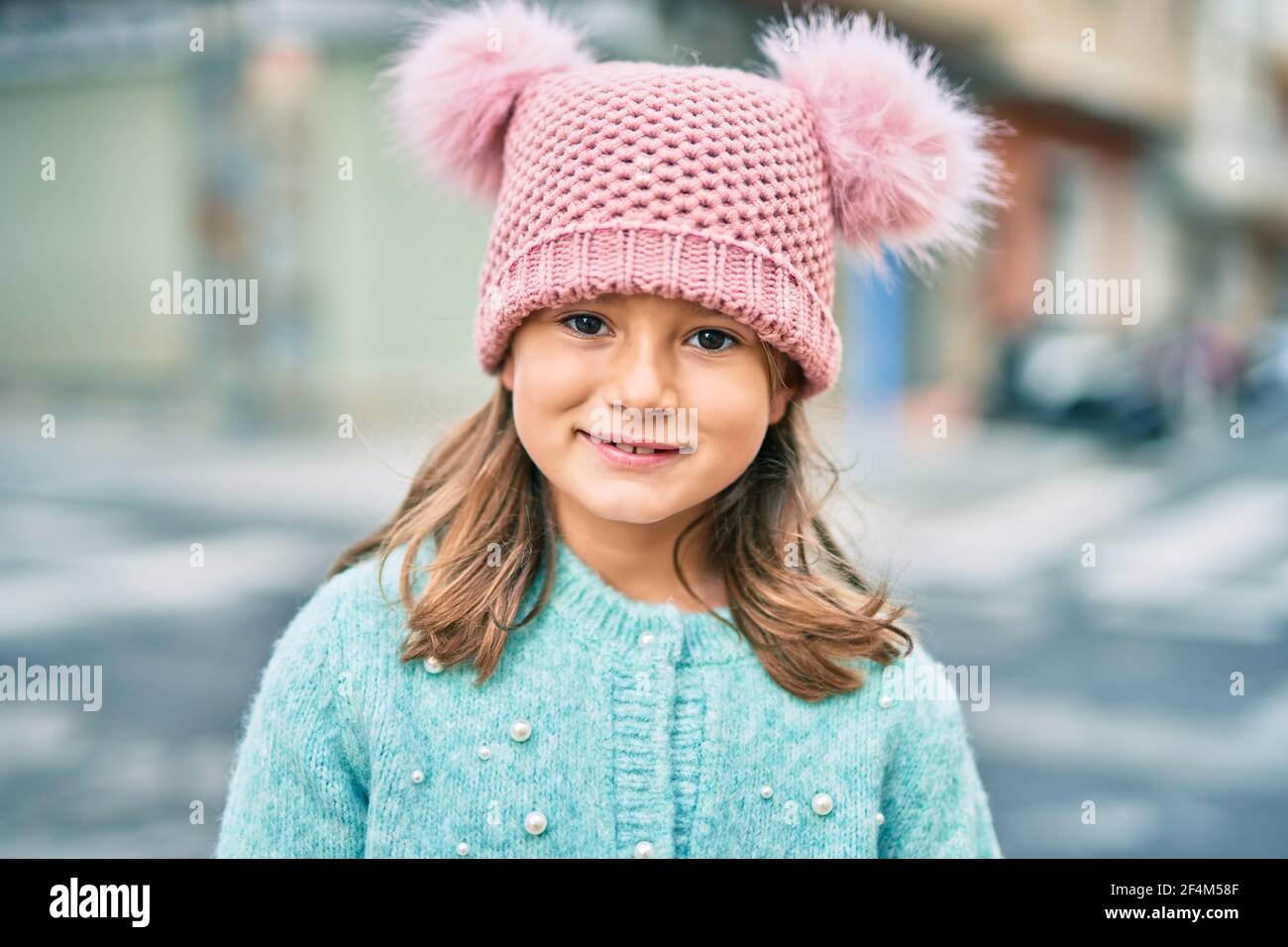 Adorable caucasian child girl smiling happy standing at the city Stock ...