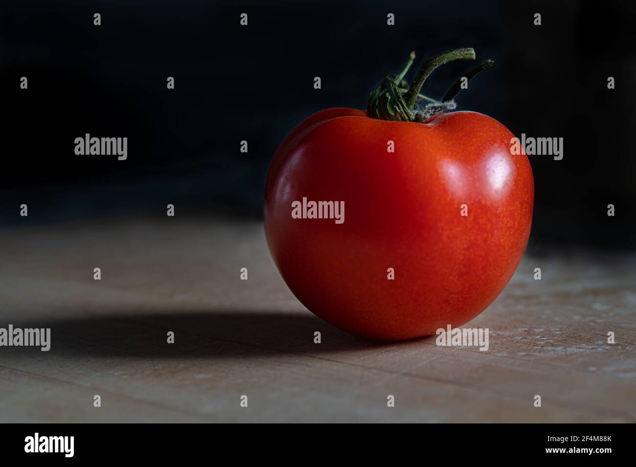 Ripe Tomato on Black Background Stock Photo
