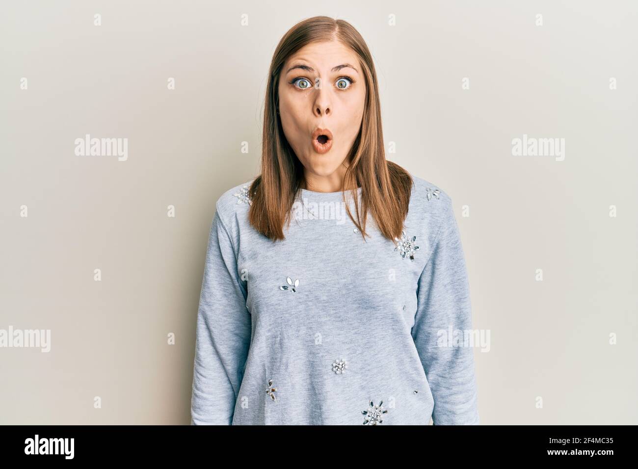 Beautiful caucasian woman wearing casual clothes scared and amazed with