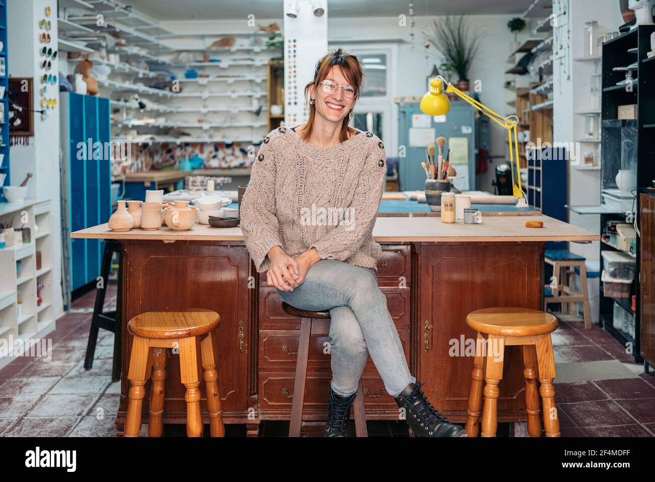 Stock photo of successful woman owner of pottery academy smiling and ...