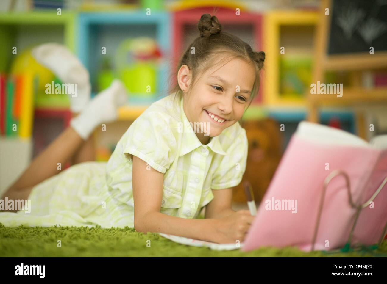 Portrait of cute little girl studying at home Stock Photo - Alamy