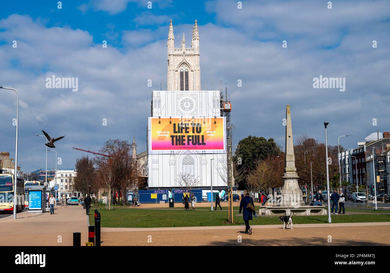 Brighton UK 22nd March 2021 - A lovely day for a walk past Brighton's St Peter's Church in beautiful warm Spring sunshine but much colder weather is forecast for later in the week throughout Britain :  Credit Simon Dack / Alamy Live News Stock Photo