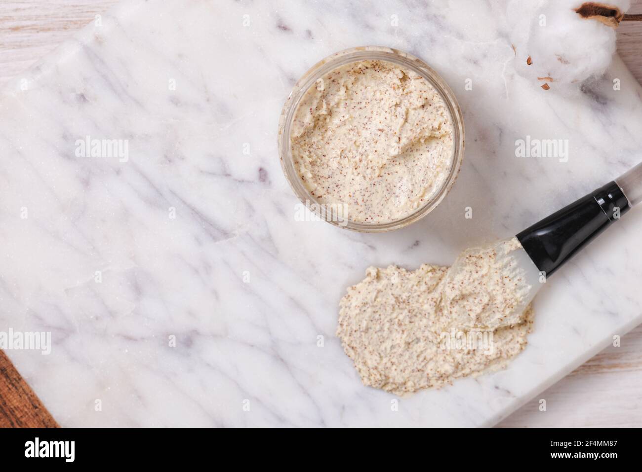 Natural body scrub on marble background. Cosmetic face cream container with care cruelty-free product. Flat lay, top view Stock Photo