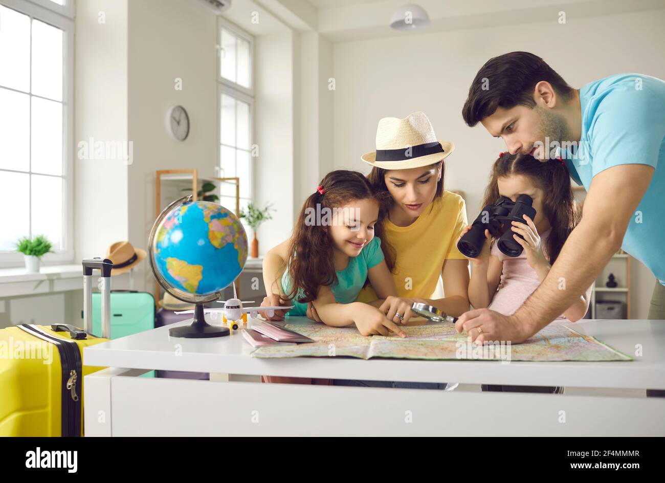 Mother father with daughter children family search tourist route on paper map Stock Photo