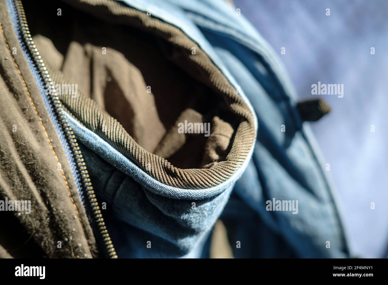 Fragment of a hooded vest with a zipper for clothing, in natural sunlight. Clothing repair concept.  Stock Photo