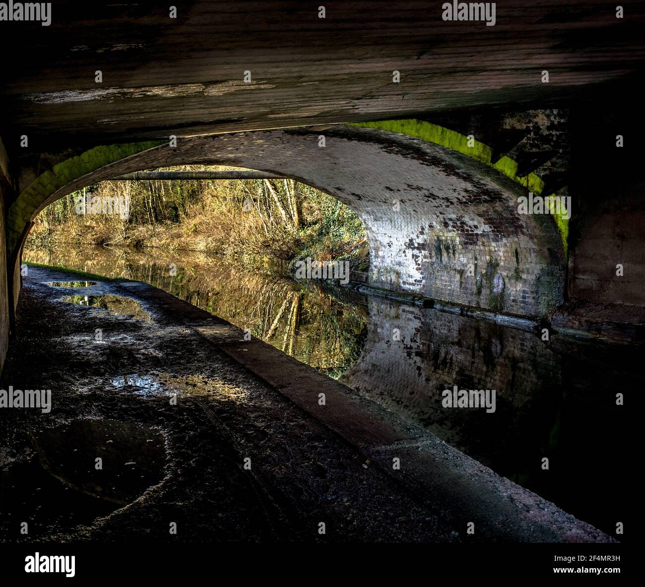 A small tunnel on the Trent And Mersey Canal with dayglo paint, warning of a low clearance for narrowboats. Stock Photo