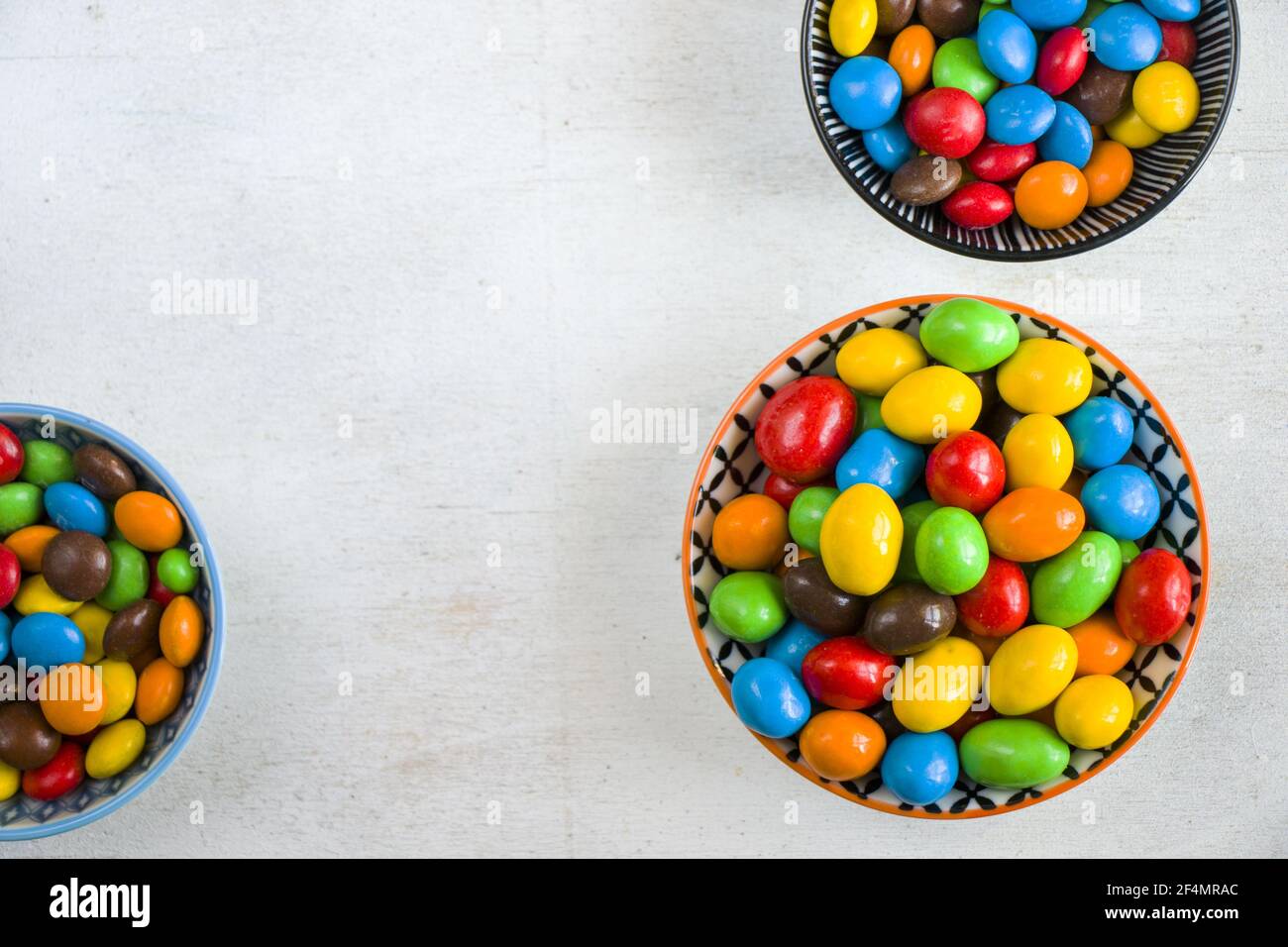 M&M's candy in the bowl on the white background, colorful candy texture ...