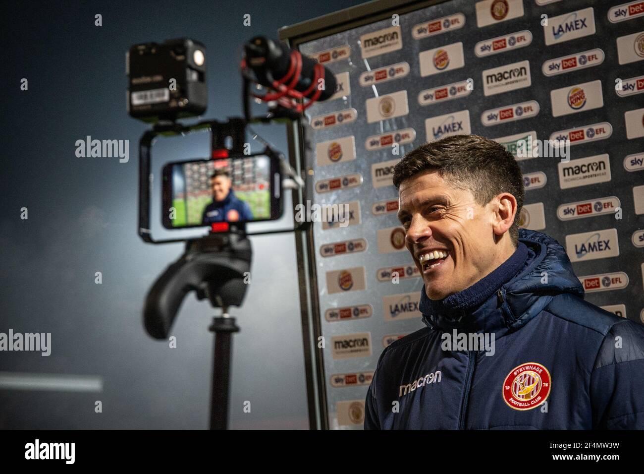 Football coach Alex Revell smiles during end of match press conference at Lamex Stadium, home of Stevenage Football Club Stock Photo