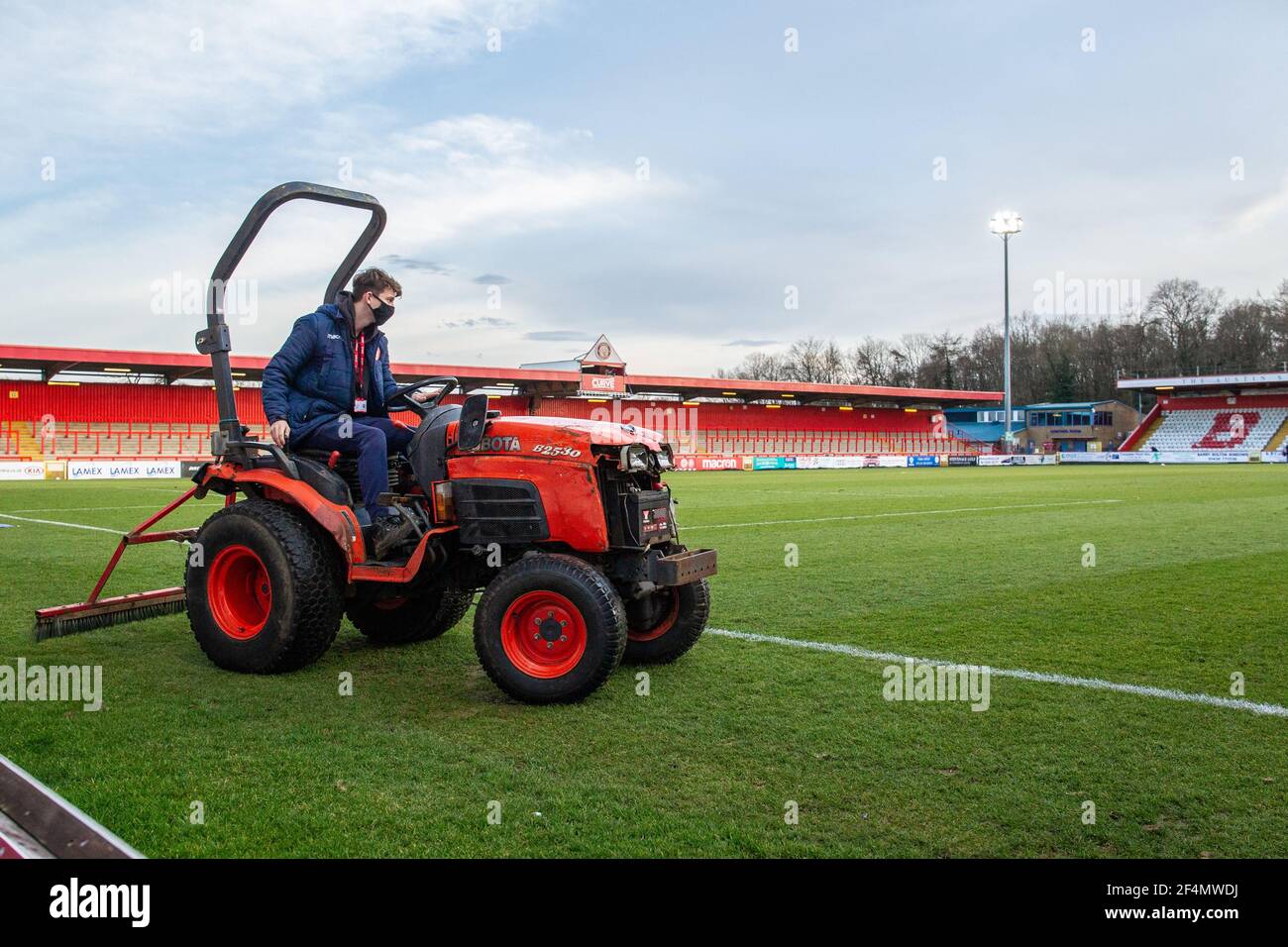 Groundsman riding tractor and maintaining football pitch at Lamex Stadium, Stevenage Football Club, Hertfordshire Stock Photo