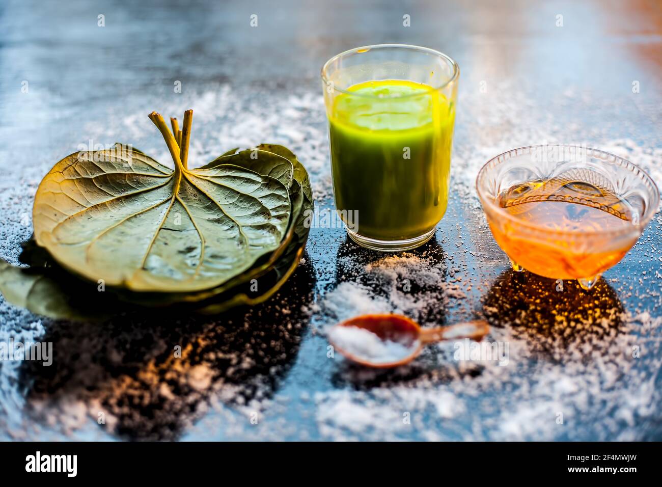 Face mask for controlling oiliness consisting of betel leaves juice, honey,  sea-salt on a black wooden surface Stock Photo - Alamy