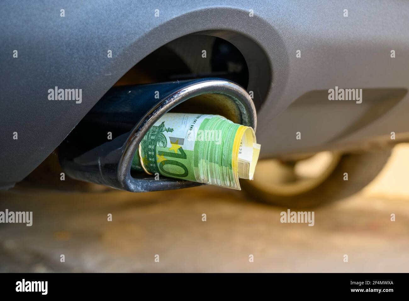 Blow the money through the exhaust Stock Photo