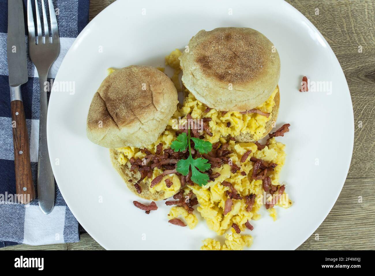bun, scrambled egg and bacon on a plate Stock Photo - Alamy