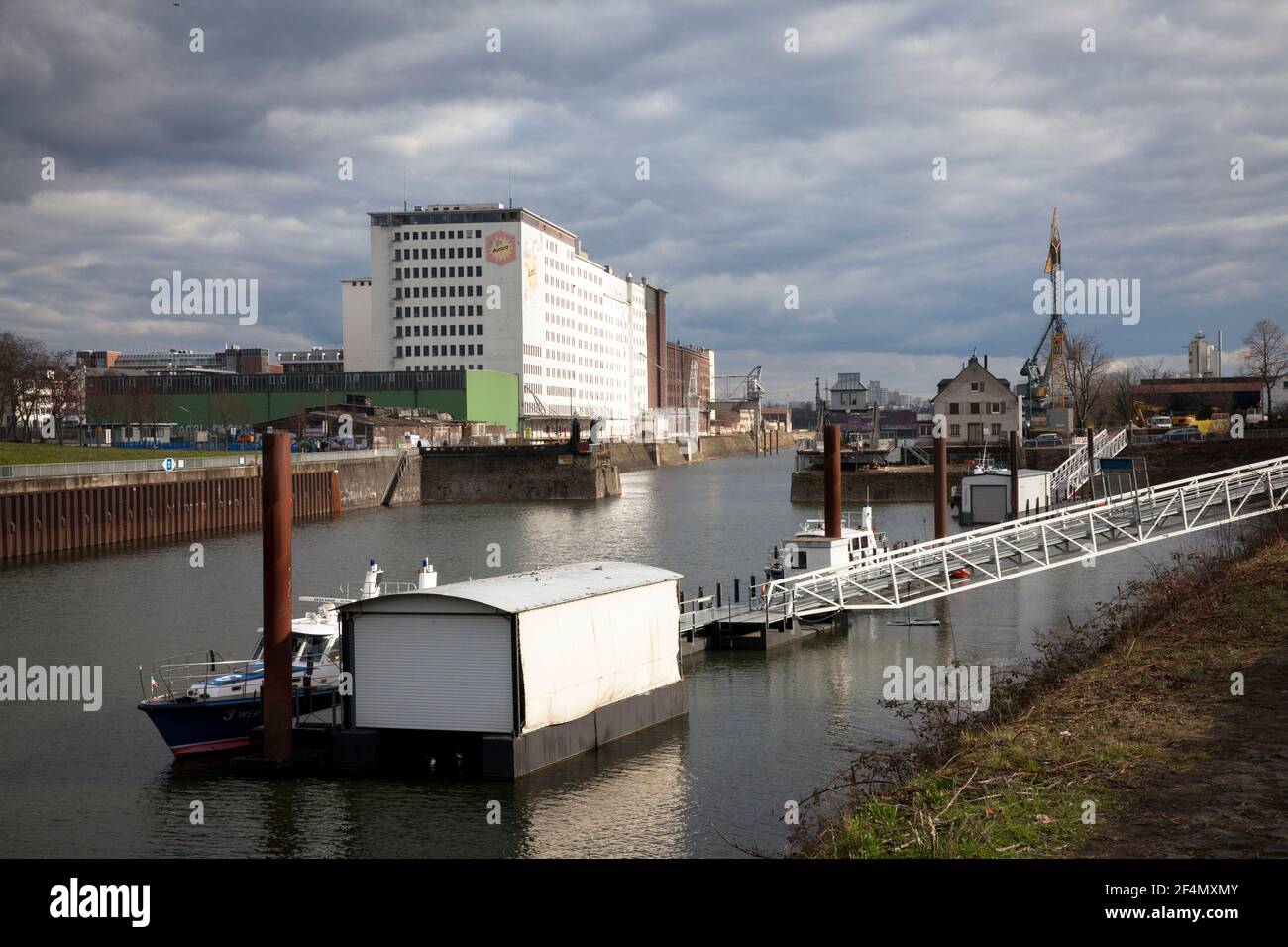 jetty for police and fire boats and the Ellmill or Aurora Mill in Deutz Harbor, district Deutz, Cologne, Germany.  Anleger fuer Polizei- und Feuerwehr Stock Photo