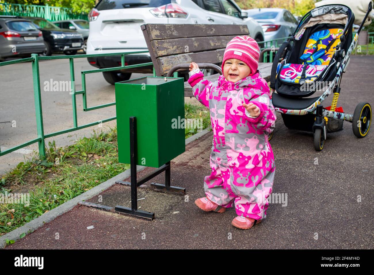 adorable child is throwing garbage in the trash Stock Photo