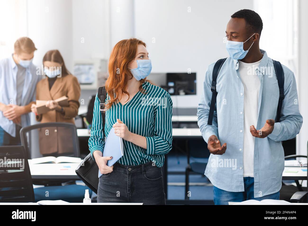 International students wearing medical masks and talking Stock Photo ...