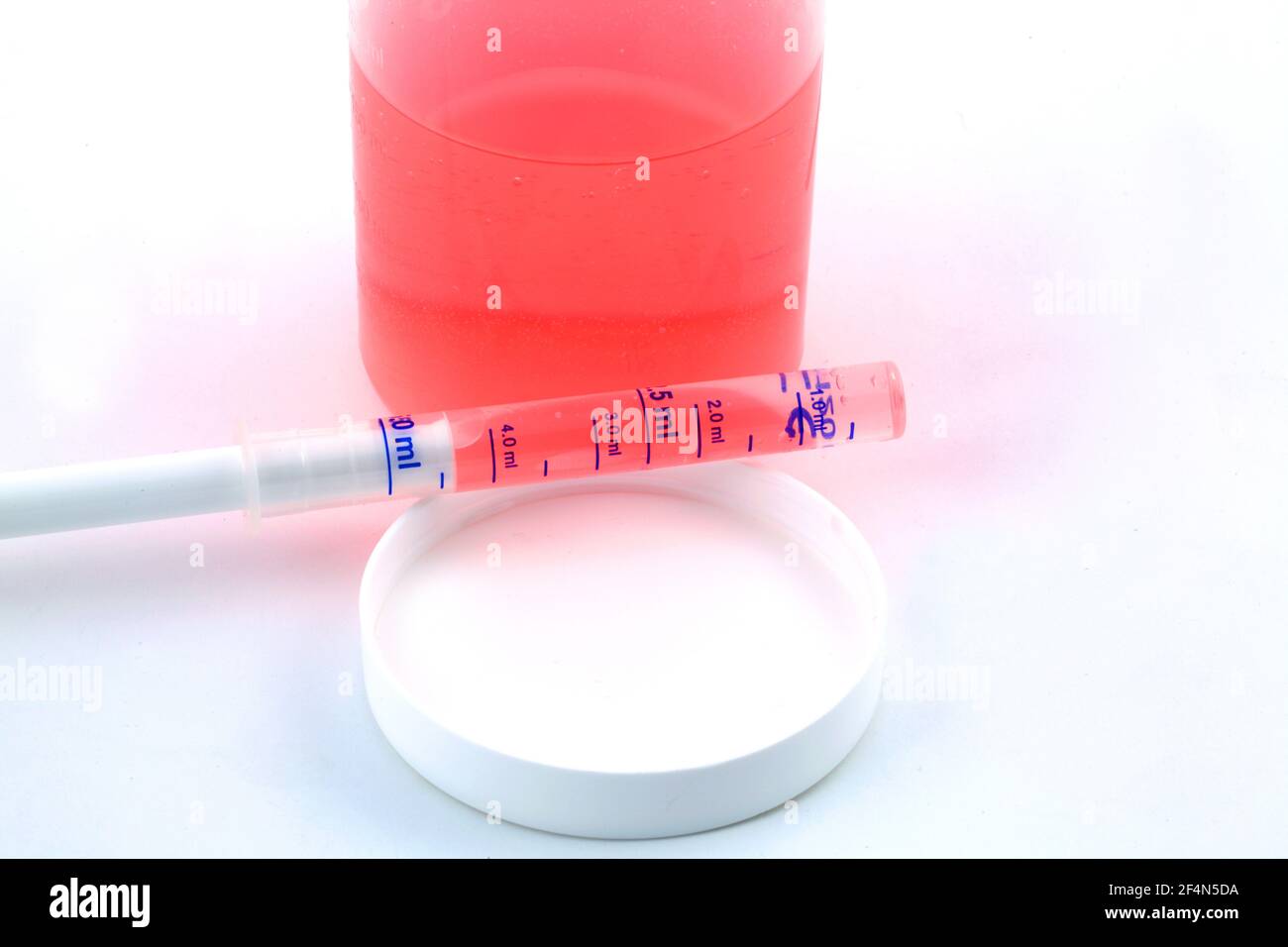 Closeup of medicine syrup in a syringe without needle on a white backgroun Stock Photo