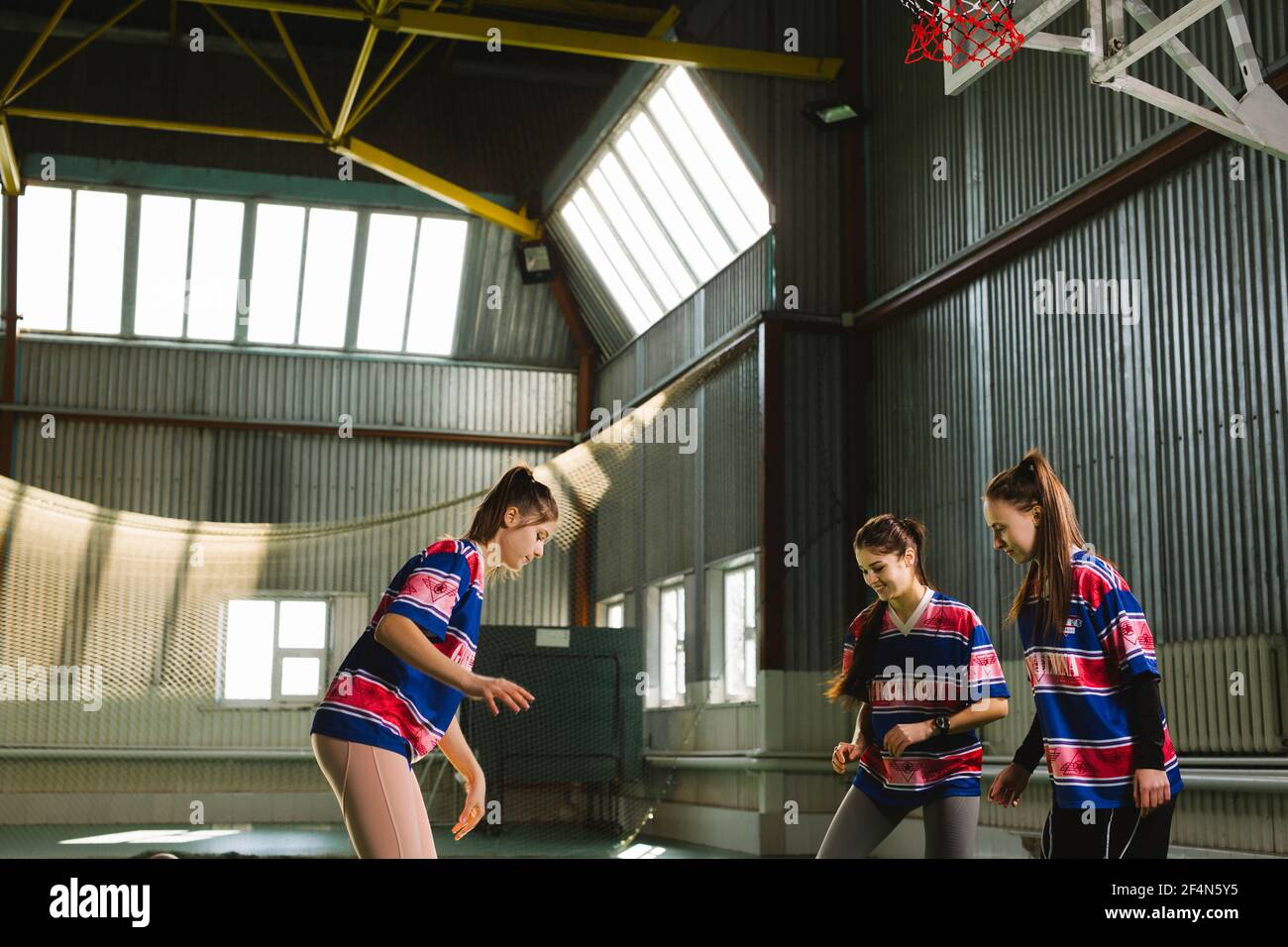 Teamwork sports. Girls wearing sport uniform playing together, indoor ...