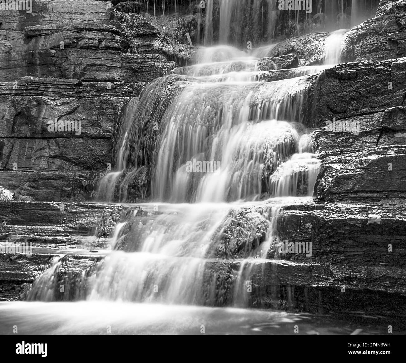 Long exposure of a waterfall in summer - black and white Stock Photo