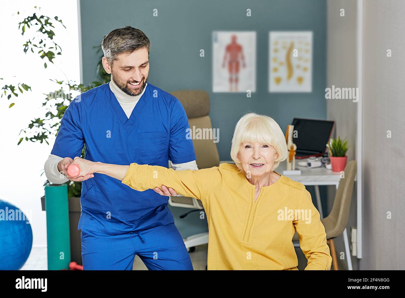 Senior patient while exercise treatment with his physiotherapist. Rehab ...