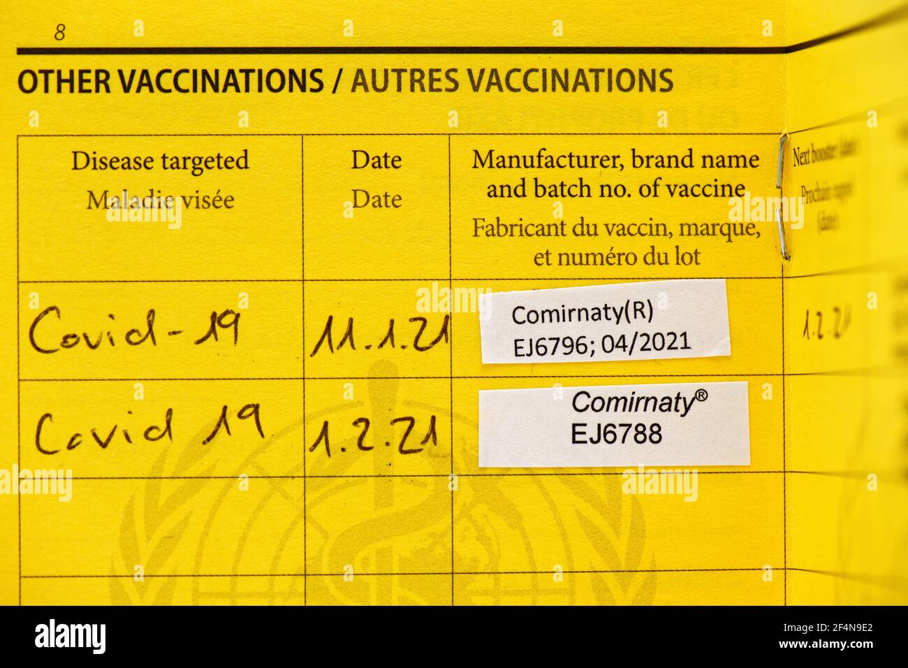2 Covid vaccinations listed in a vaccination card Stock Photo