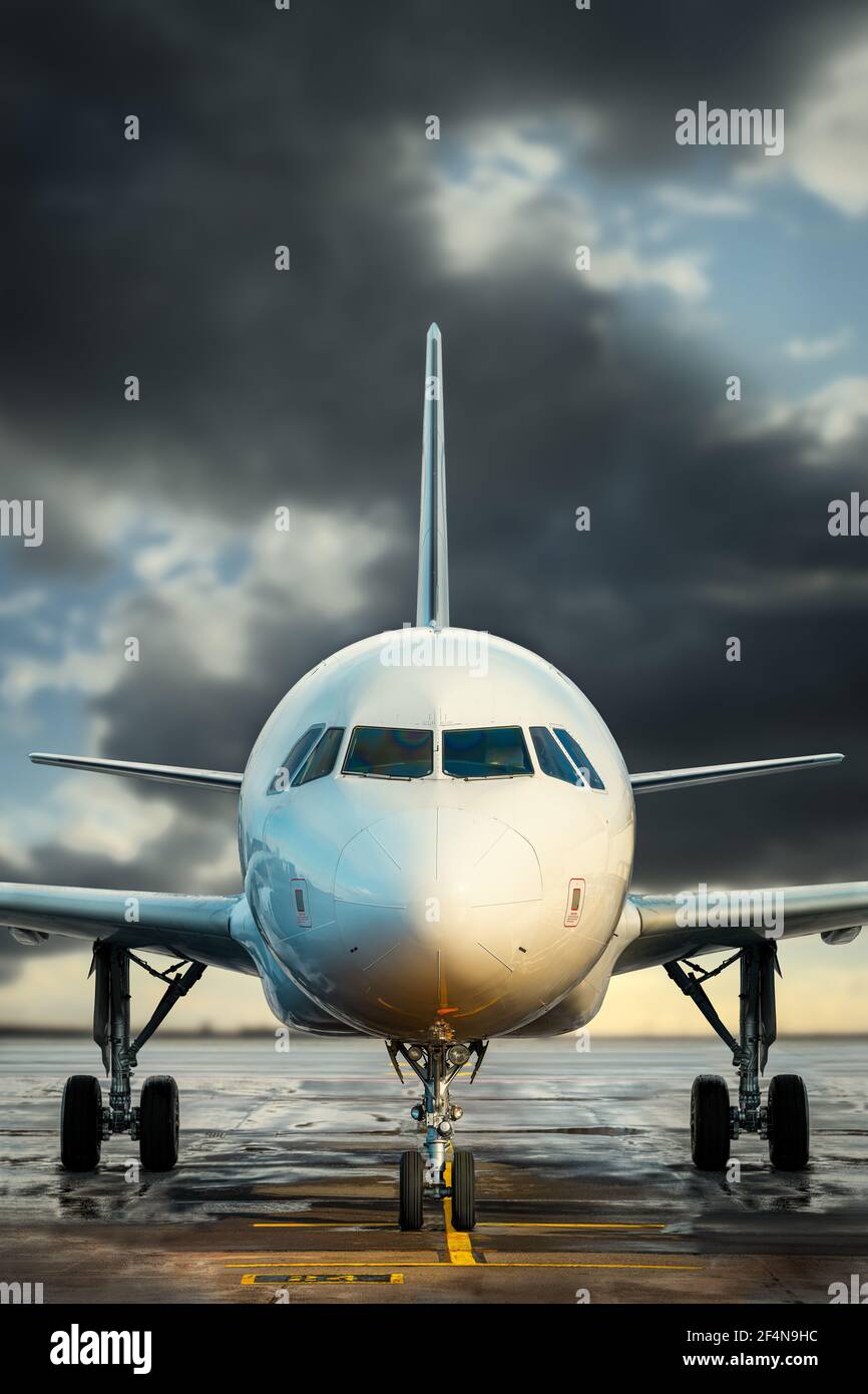 modern airplane against a dramatic sky Stock Photo
