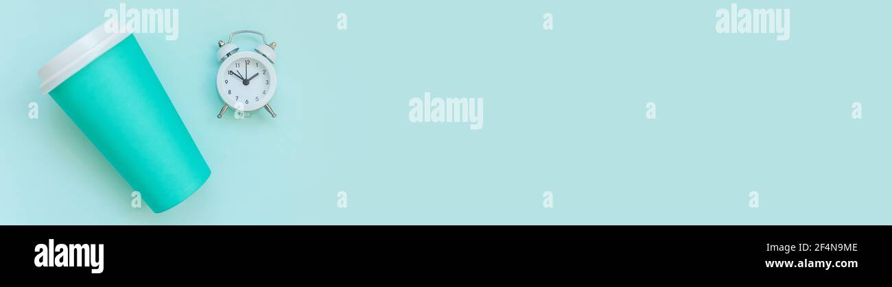 Simply flat lay design blue paper coffee cup and alarm clock isolated ...