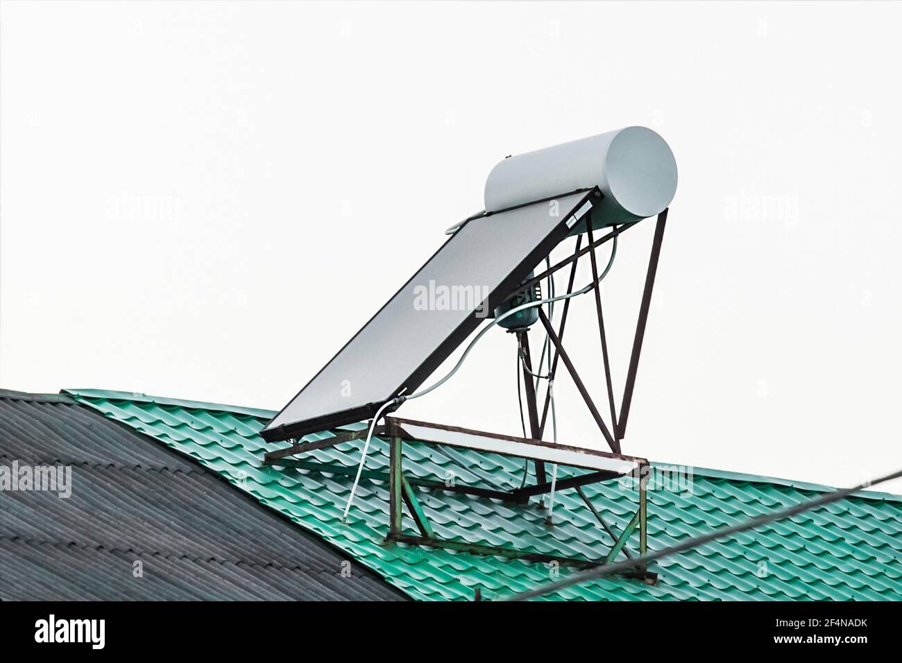 Solar water heater on the roof of a building against the background of ...