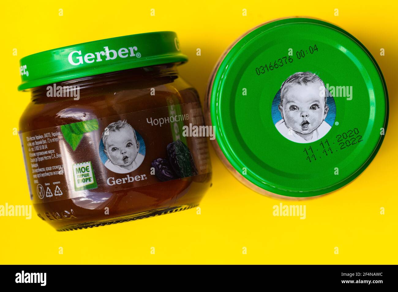 Lviv, Ukraine - March 22, 2020:  Gerber brand child nutrition prunes puree on yellow background Stock Photo