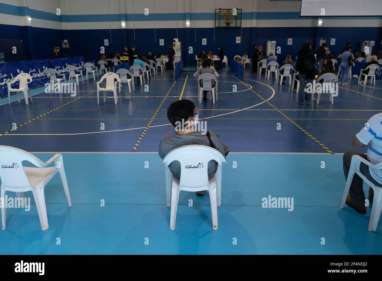 Santiago, Metropolitana, Chile. 22nd Mar, 2021. A man waits to receive the dose of the Sinovac or Pfizer vaccine, in a municipal stadium transformed into a vaccination center against covid in Santiago, Chile. Credit: Matias Basualdo/ZUMA Wire/Alamy Live News Stock Photo