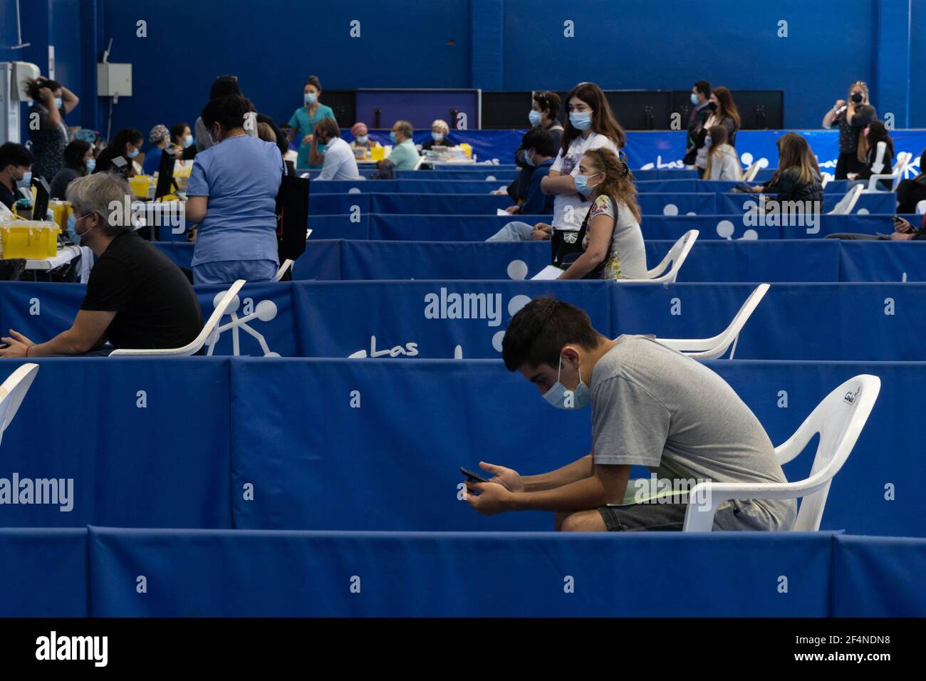 Santiago, Metropolitana, Chile. 22nd Mar, 2021. People wait to receive the dose of the Sinovac or Pfizer vaccine, in a municipal stadium transformed into a vaccination center against covid in Santiago, Chile. Credit: Matias Basualdo/ZUMA Wire/Alamy Live News Stock Photo