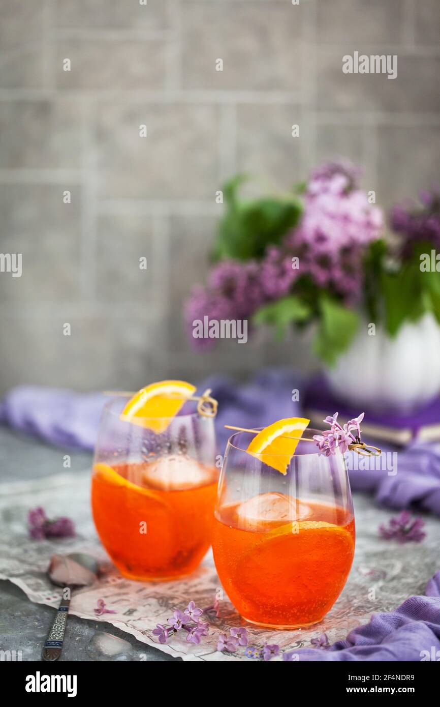 Orange Aperol Spritz cocktail served in a wine glasses, decorated with ...