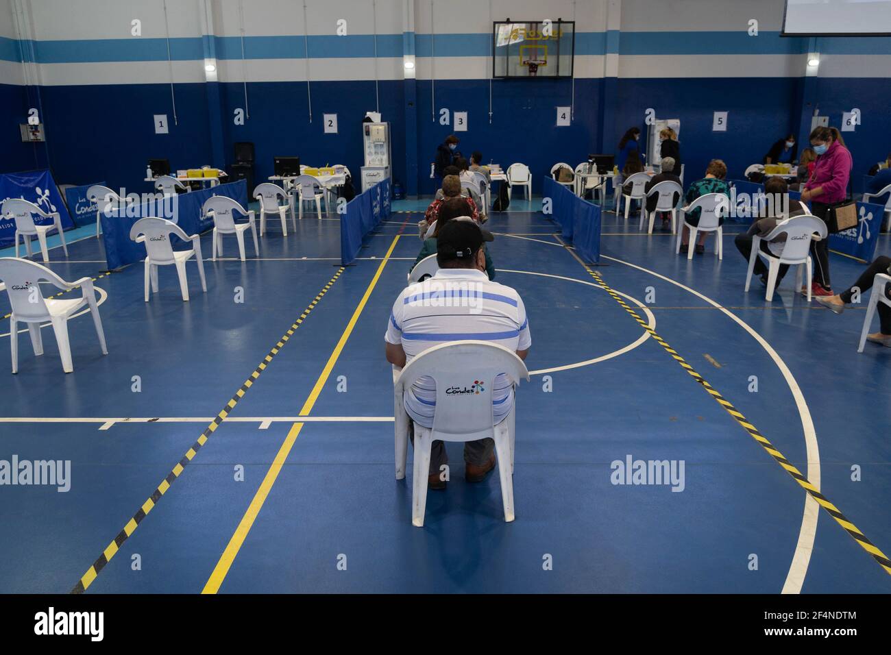 Santiago, Metropolitana, Chile. 22nd Mar, 2021. A man waits in line to receive the dose of the Sinovac or Pfizer vaccine, in a municipal stadium transformed into a vaccination center against covid in Santiago, Chile. Credit: Matias Basualdo/ZUMA Wire/Alamy Live News Stock Photo