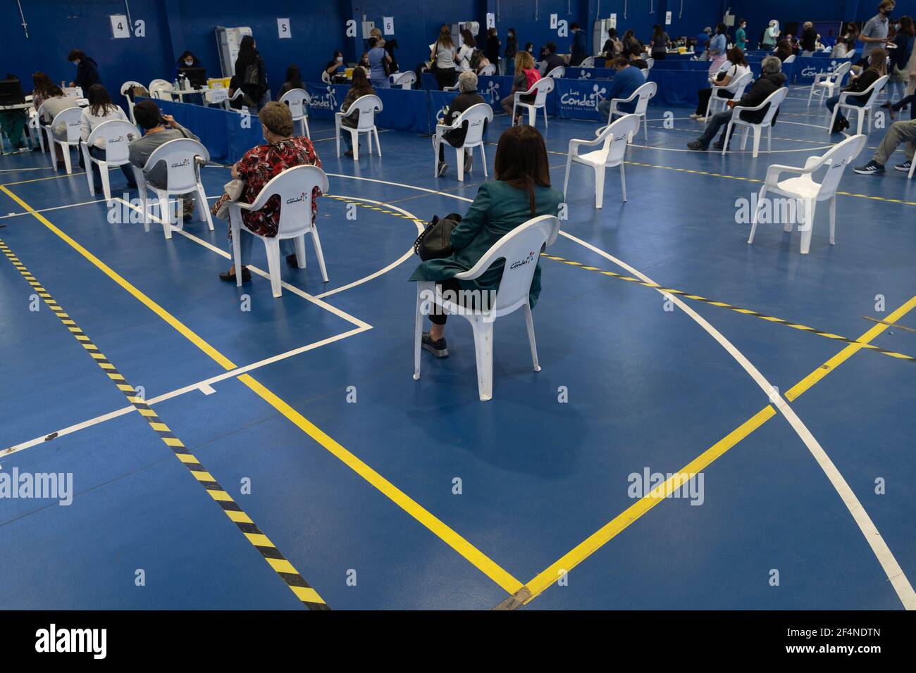 Santiago, Metropolitana, Chile. 22nd Mar, 2021. People wait to receive the dose of the Sinovac or Pfizer vaccine, in a municipal stadium transformed into a vaccination center against covid in Santiago, Chile. Credit: Matias Basualdo/ZUMA Wire/Alamy Live News Stock Photo