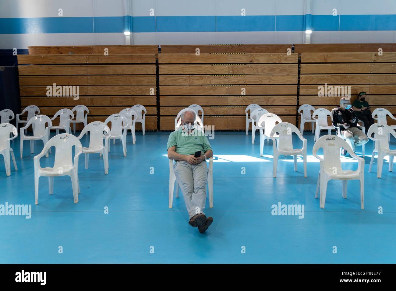 Santiago, Metropolitana, Chile. 22nd Mar, 2021. A man waits to receive the dose of the Sinovac or Pfizer vaccine, in a municipal stadium transformed into a vaccination center against covid in Santiago, Chile. Credit: Matias Basualdo/ZUMA Wire/Alamy Live News Stock Photo