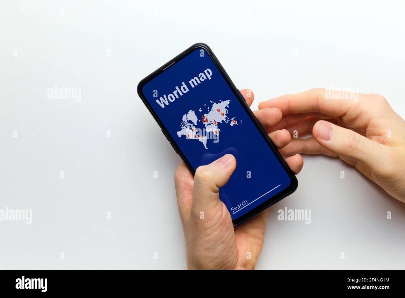 Person holds in hand a smartphone with a world map with search Stock ...
