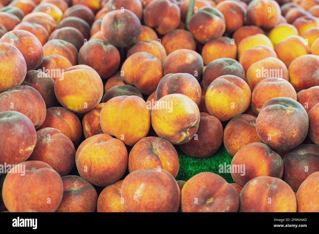 Pile of Fresh Yellow Peaches For Sale at Farmer's Market Stock Photo