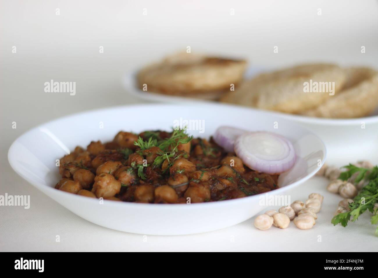 Spicy chickpea gravy with fried Indian flat bread. Locally known as