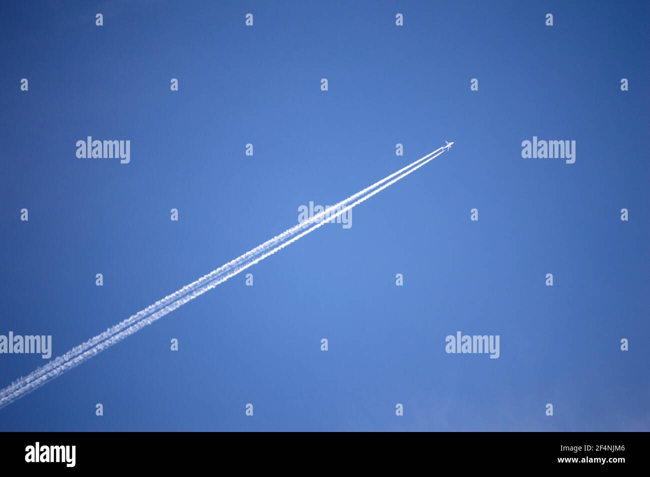 Airplane and jet stream with clear blue skies backgound Stock Photo Alamy